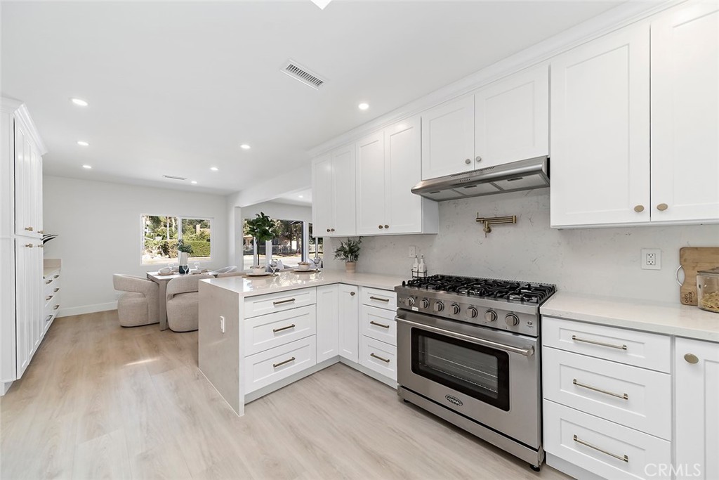 732 East Foothill Boulevard Glendora, CA 91741 - Photo 12 of 61 a kitchen with stainless steel appliances white cabinets and a stove top oven