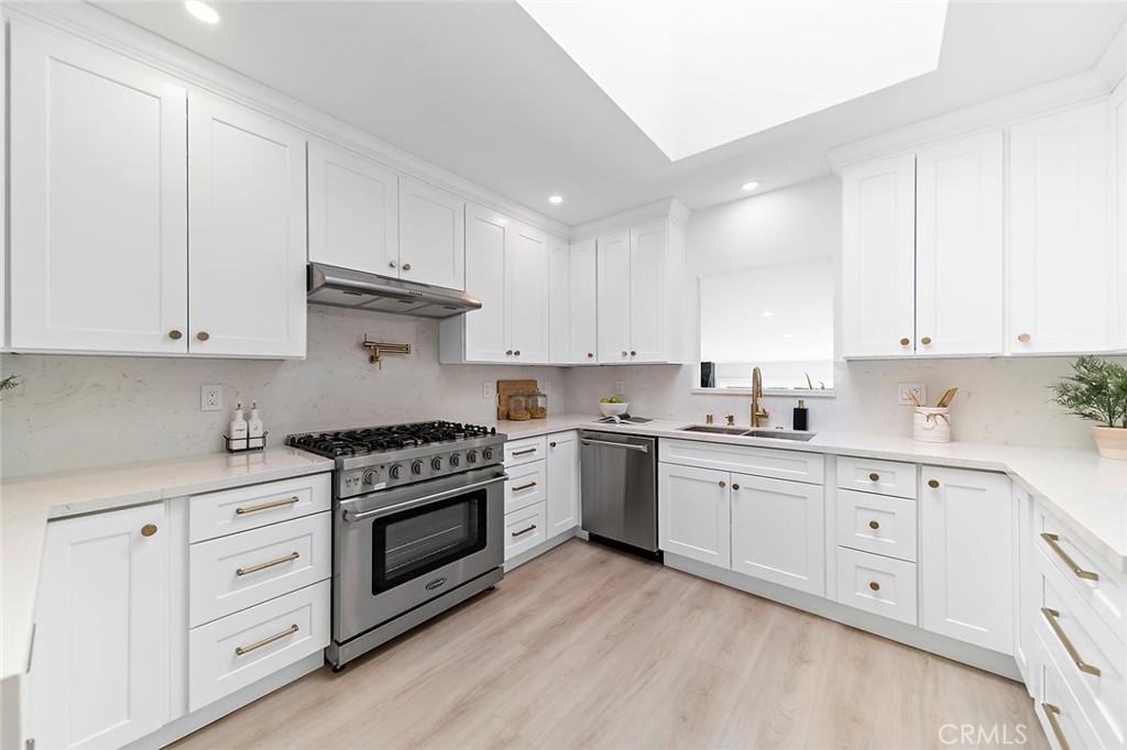 732 East Foothill Boulevard Glendora, CA 91741 - Photo 13 of 61 a kitchen with granite countertop white cabinets and white stainless steel appliances