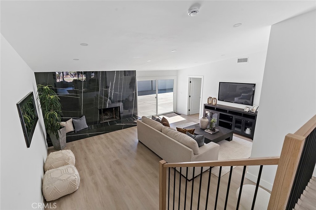 732 East Foothill Boulevard Glendora, CA 91741 - Photo 18 of 61 a living room with furniture a flat screen tv and a fireplace