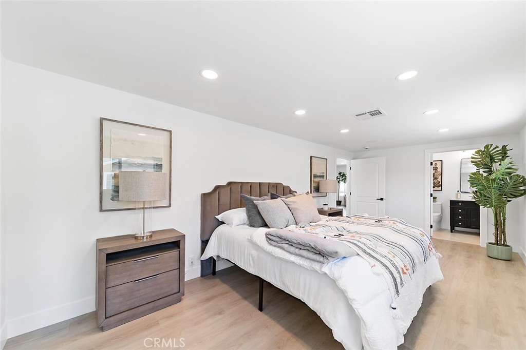 732 East Foothill Boulevard Glendora, CA 91741 - Photo 23 of 61 a bed room with a bed and a lamp