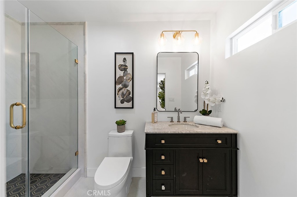 732 East Foothill Boulevard Glendora, CA 91741 - Photo 25 of 61 a bathroom with a toilet a sink and mirror