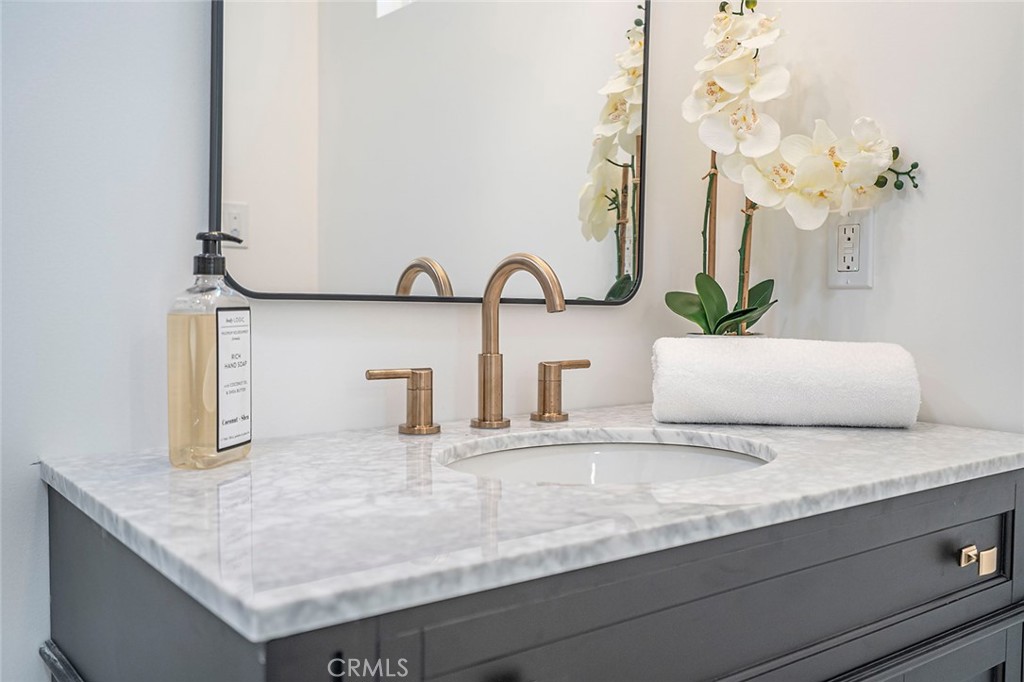 732 East Foothill Boulevard Glendora, CA 91741 - Photo 27 of 61 a bathroom with a granite countertop sink and a mirror
