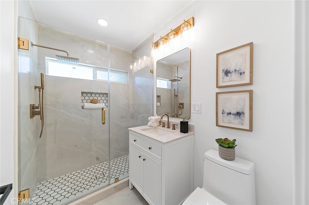 732 East Foothill Boulevard Glendora, CA 91741 - Photo 32 of 61 a bathroom with a sink mirror and toilet
