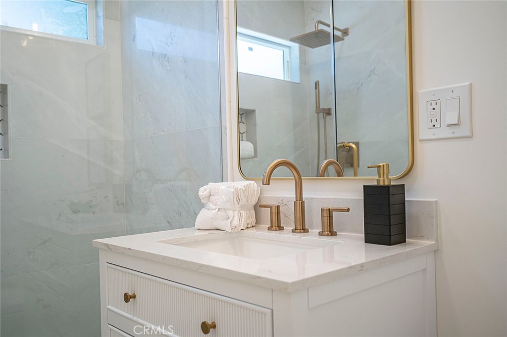 732 East Foothill Boulevard Glendora, CA 91741 - Photo 33 of 61 a close view of a sink a light fixture and a bathroom with a sink