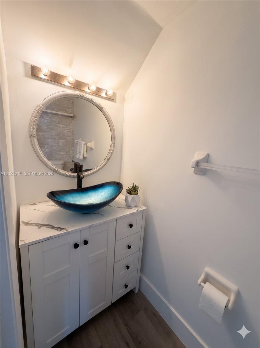 13 Southwest 3rd Street, Unit 13 Pompano Beach, FL 33060 - Photo 11 of 44 a bathroom with a mirror and vanity
