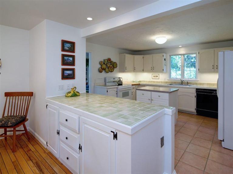 35 Quaker Road Falmouth, MA 02540 - Photo 11 of 22 a kitchen with granite countertop a sink and cabinets