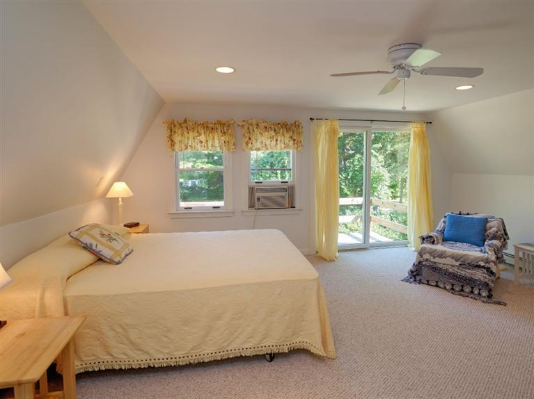 35 Quaker Road Falmouth, MA 02540 - Photo 13 of 22 a bedroom with a bed and glass window