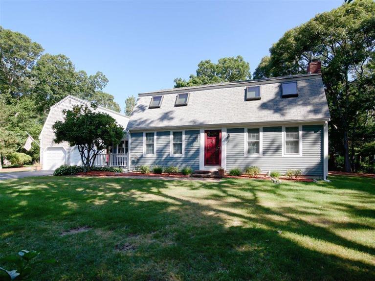 35 Quaker Road Falmouth, MA 02540 - Photo 19 of 22 a view of a brick house with a big yard and large trees