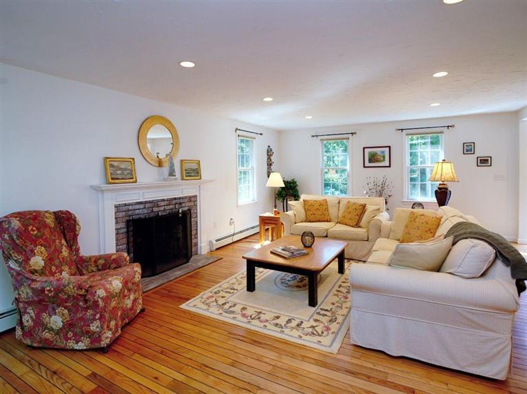 35 Quaker Road Falmouth, MA 02540 - Photo 6 of 22 a living room with furniture a fireplace and a large window