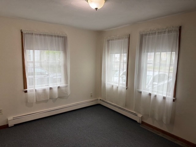 294 Pond Street, Unit 1 Braintree, MA 02184 - Photo 12 of 15 an empty room with a window
