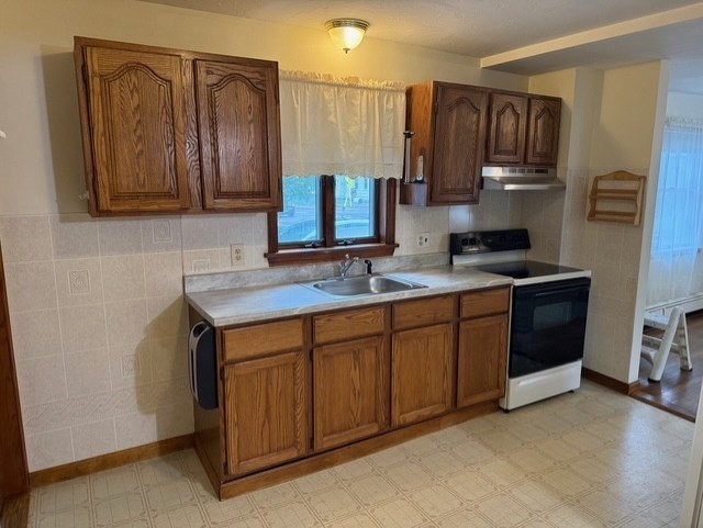 294 Pond Street, Unit 1 Braintree, MA 02184 - Photo 3 of 15 a kitchen with stainless steel appliances granite countertop a sink stove and cabinets