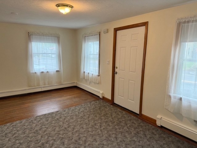 294 Pond Street, Unit 1 Braintree, MA 02184 - Photo 6 of 15 an empty room with windows