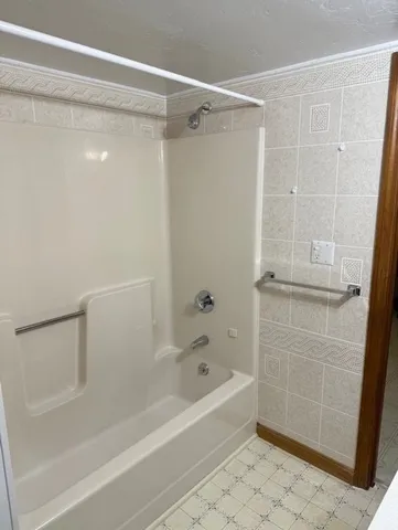 a bathroom with a shower and a bath tub
