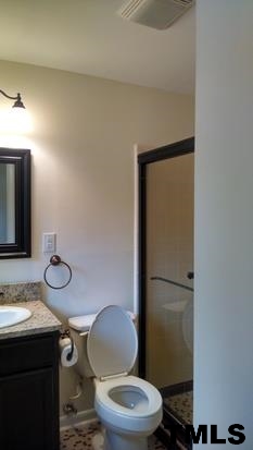 4408 Greenbrier Road Raleigh, NC 27603 - Photo 6 of 9 a bathroom with a toilet a sink and mirror