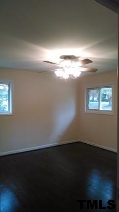 4408 Greenbrier Road Raleigh, NC 27603 - Photo 8 of 9 an empty room with wooden floor and windows