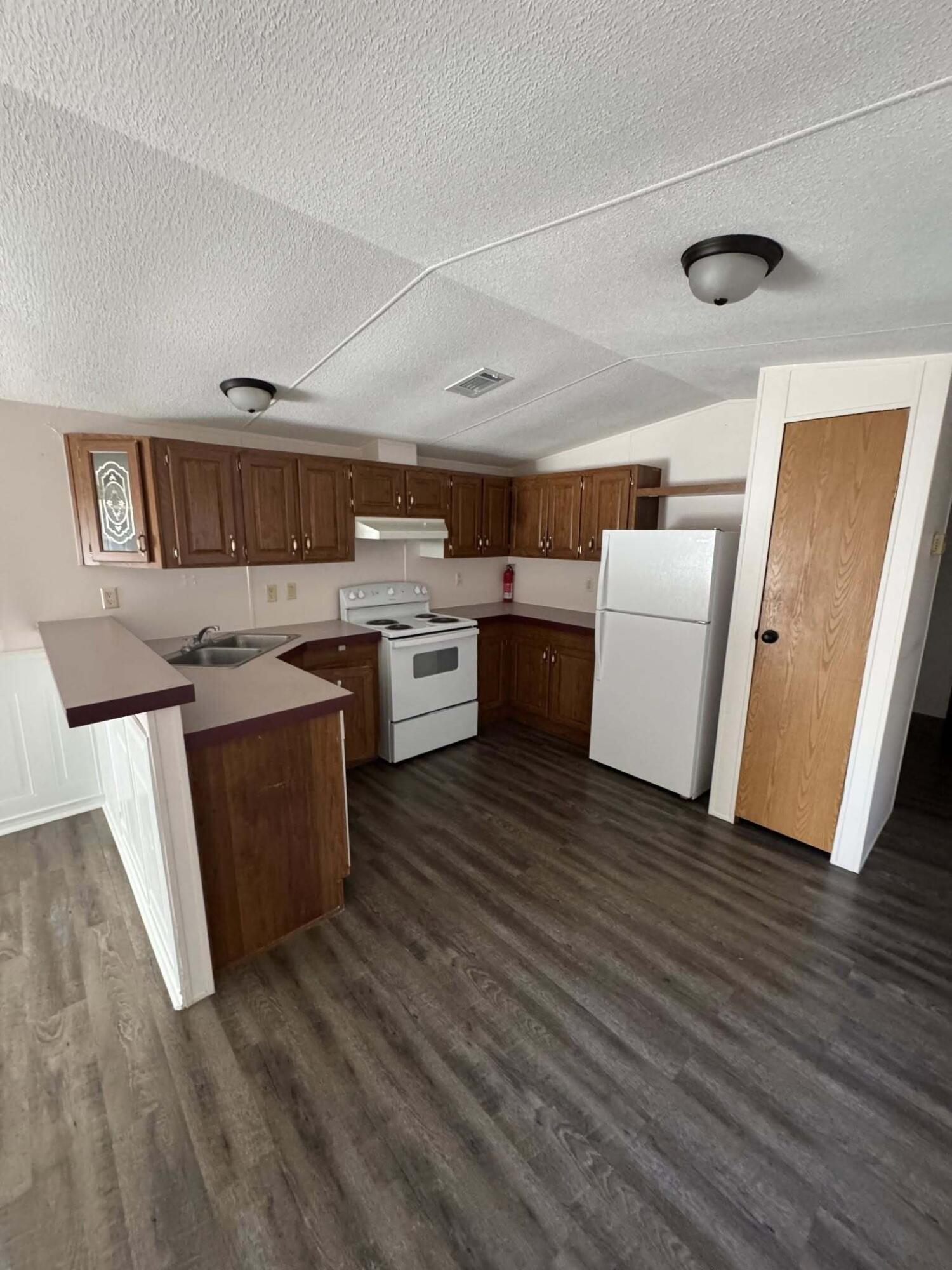 263 Lancelot Road DeFuniak Springs, FL 32433 - Photo 3 of 6 a kitchen with stainless steel appliances granite countertop a stove a sink dishwasher and a refrigerator
