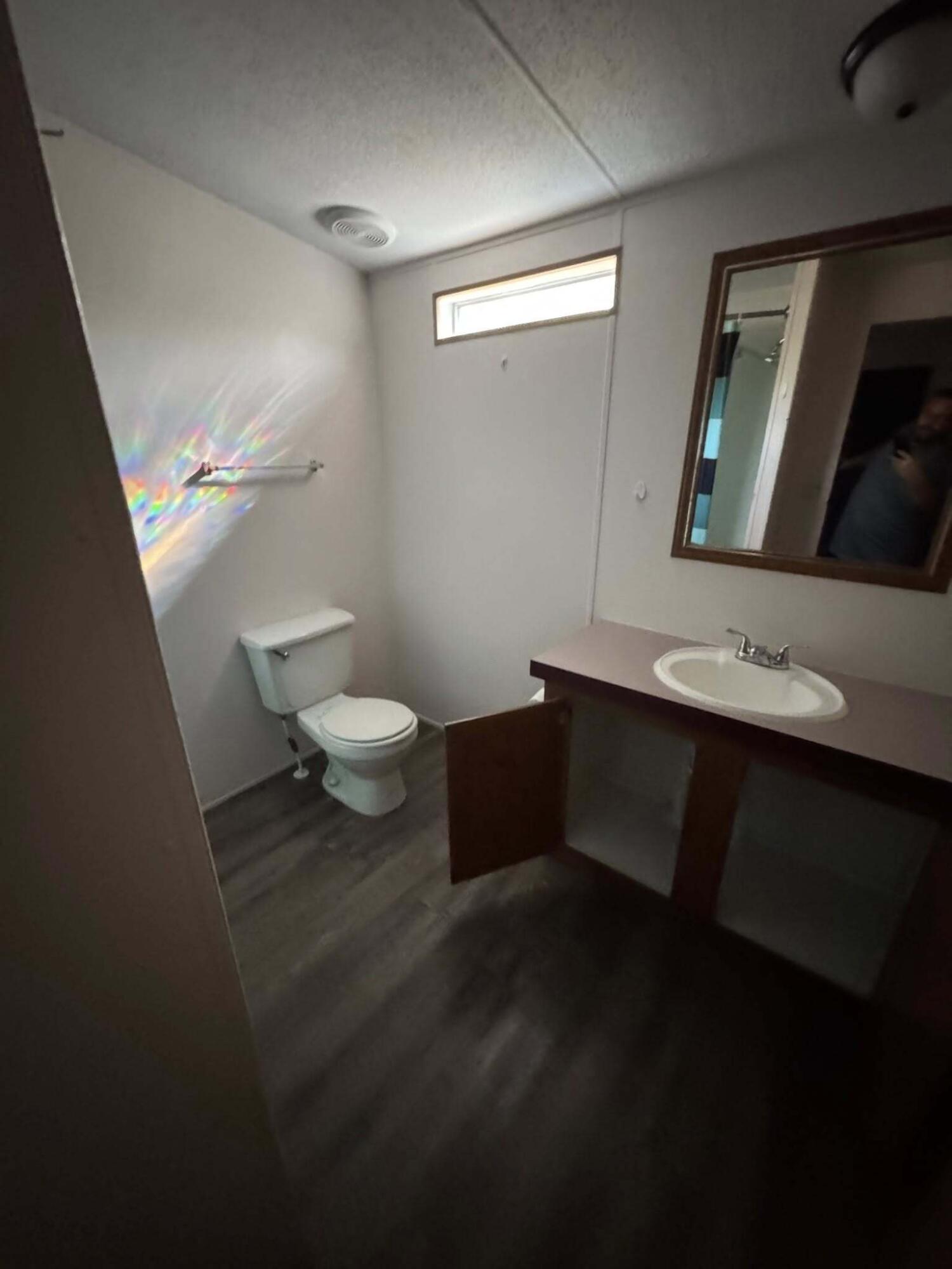 263 Lancelot Road DeFuniak Springs, FL 32433 - Photo 4 of 6 a bathroom with a sink a toilet and mirror