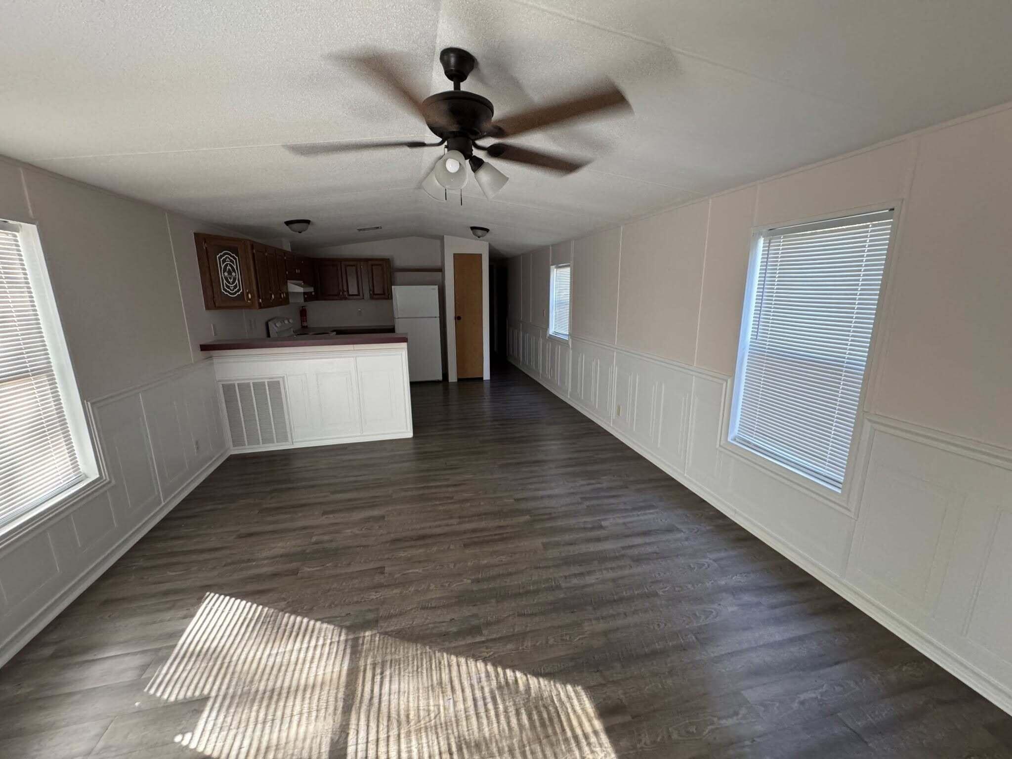 263 Lancelot Road DeFuniak Springs, FL 32433 - Photo 6 of 6 a view of a livingroom with a hardwood floor and a ceiling fan