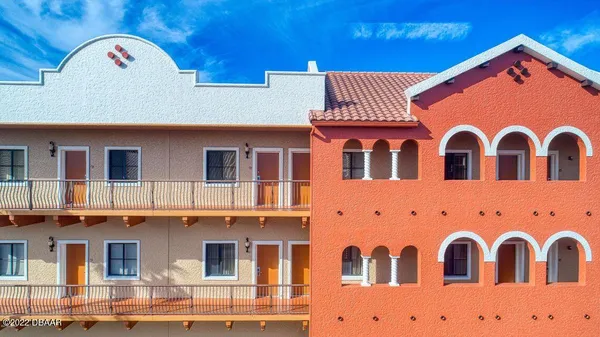 a front view of a building with parking space
