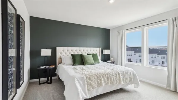 a bedroom with a large bed and a large window