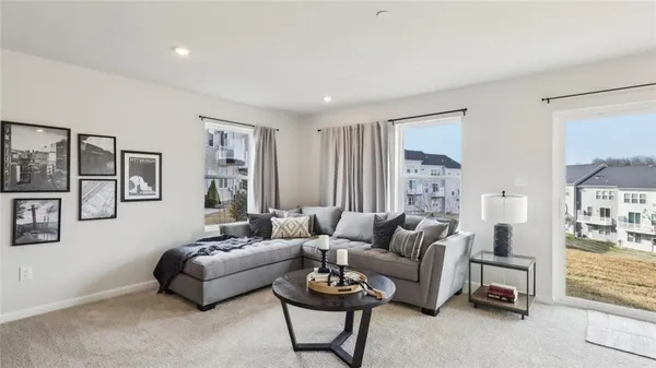 a living room with furniture and a potted plant