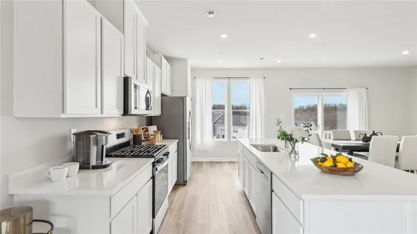 a kitchen filled counter top space a sink wooden floor and cabinets