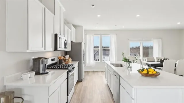 a kitchen filled counter top space a sink wooden floor and cabinets