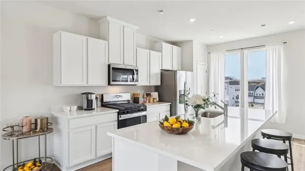 a kitchen with a sink appliances and cabinets