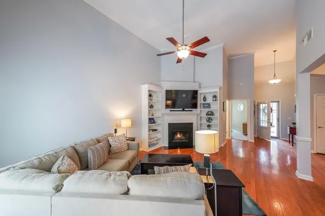 a living room with furniture a fireplace and a flat screen tv