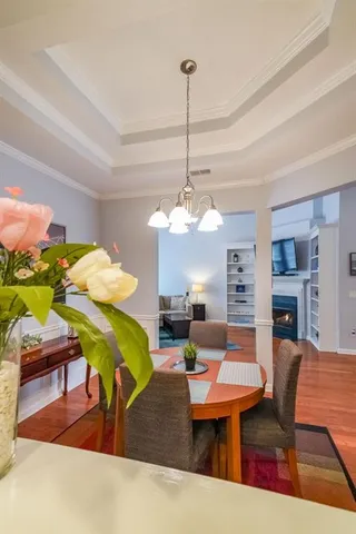 a living room with furniture a chandelier and a rug