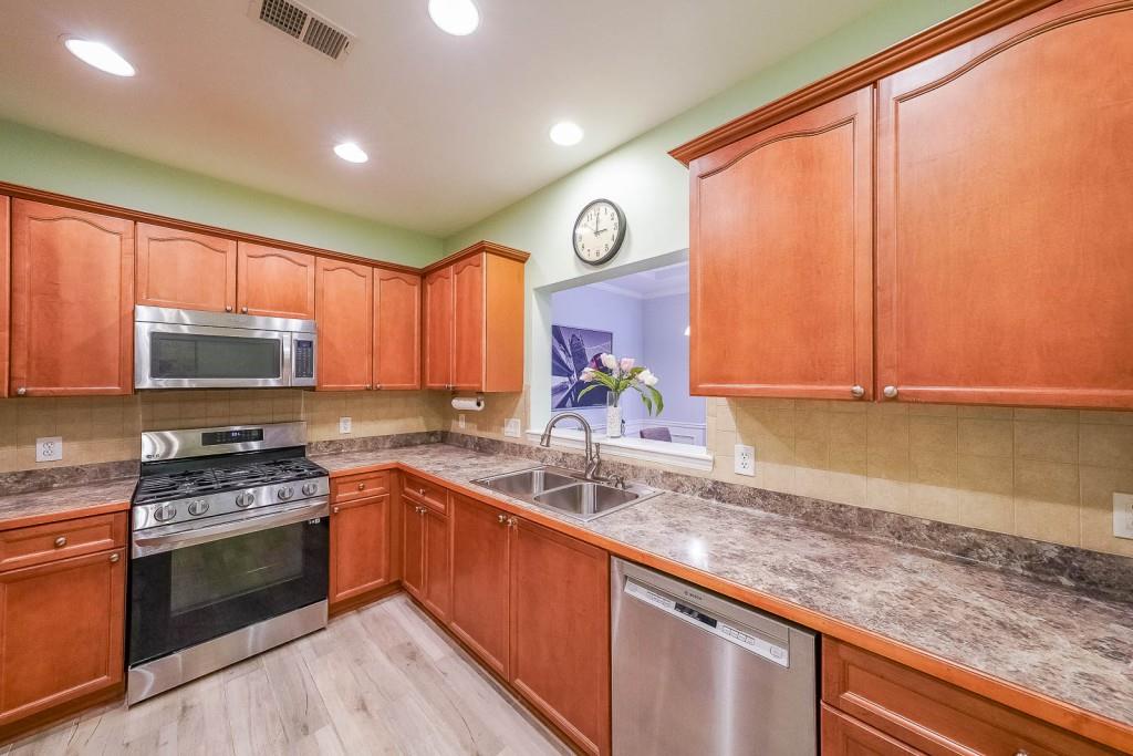 3916 Abbott Way Southwest, Unit 2 Powder Springs, GA 30127 - Photo 20 of 37 a kitchen with stainless steel appliances granite countertop a sink stove and refrigerator