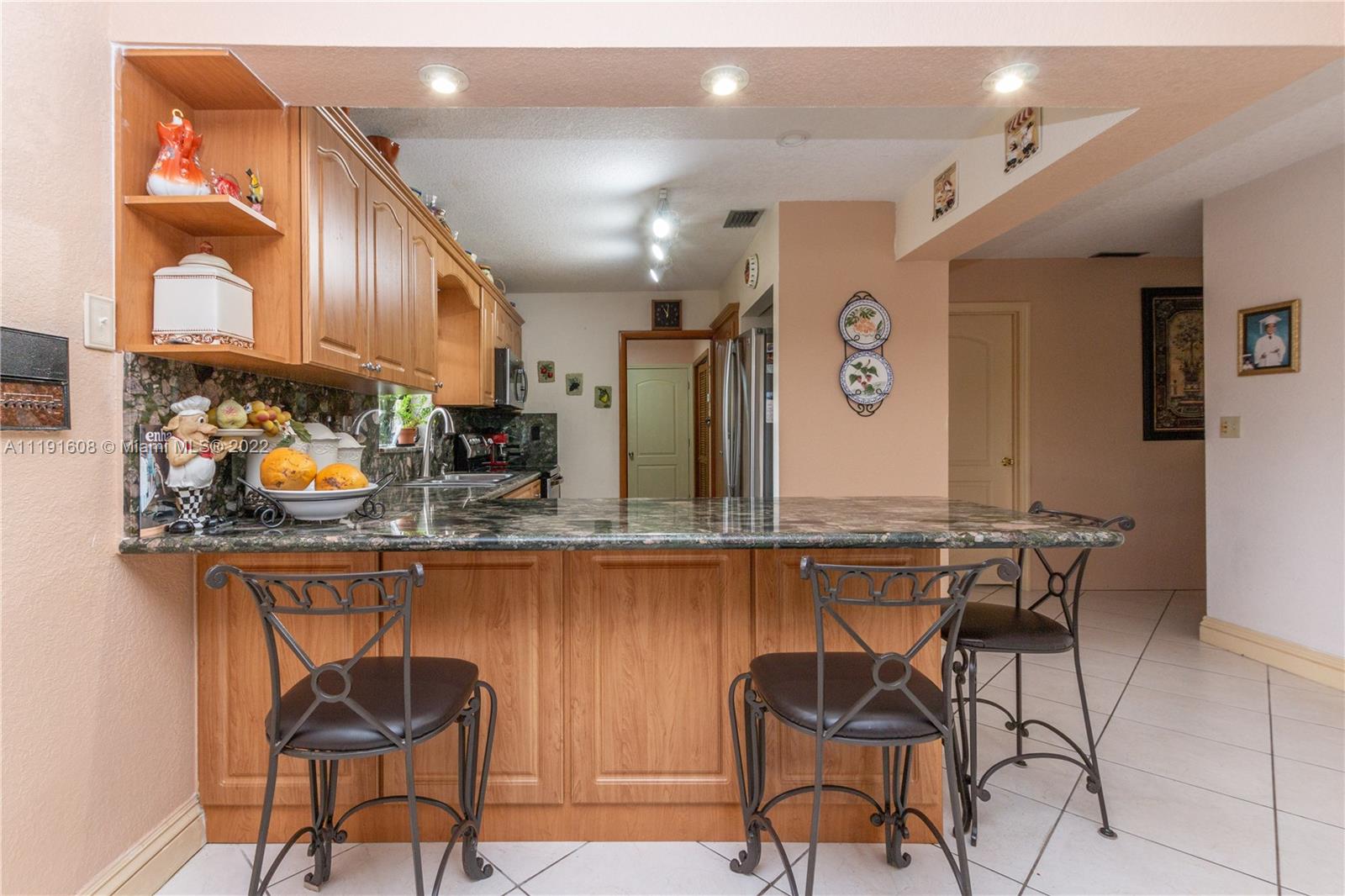 13560 Southwest 2nd Street Miami, FL 33184 - Photo 14 of 50 a view of a chairs and table in a kitchen