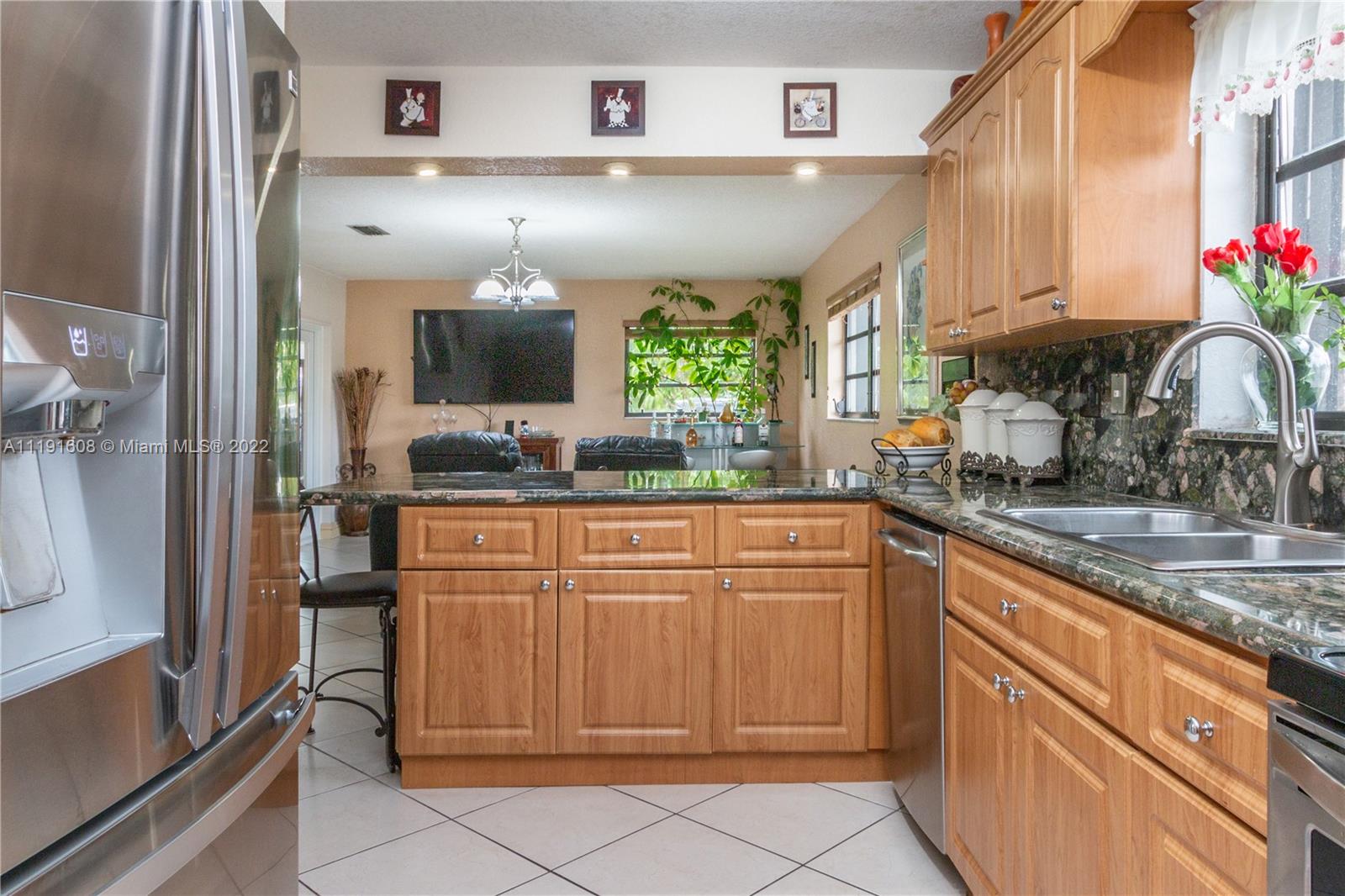 13560 Southwest 2nd Street Miami, FL 33184 - Photo 18 of 50 a kitchen with granite countertop a sink and cabinets