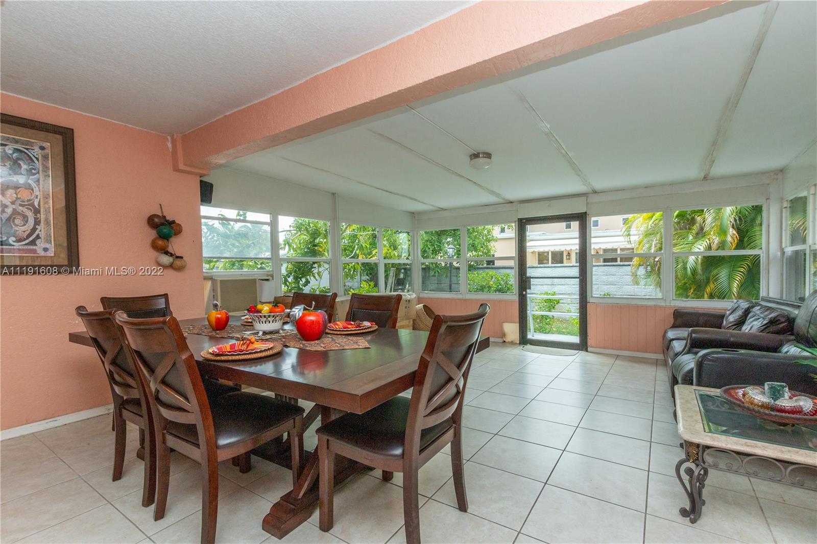 13560 Southwest 2nd Street Miami, FL 33184 - Photo 20 of 50 a dining room with furniture and a floor to ceiling window