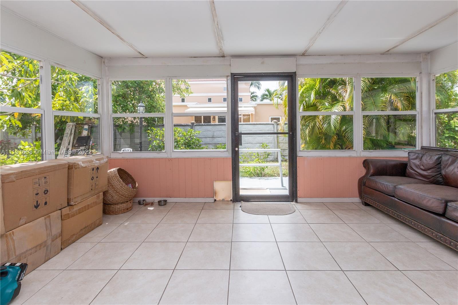 13560 Southwest 2nd Street Miami, FL 33184 - Photo 21 of 50 a living room with furniture and large windows