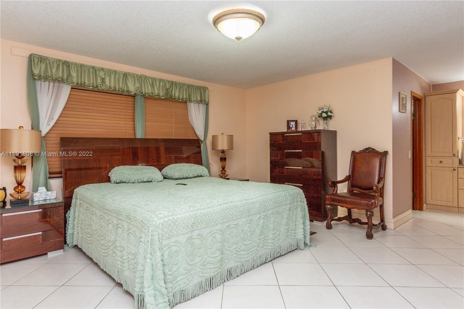13560 Southwest 2nd Street Miami, FL 33184 - Photo 24 of 50 a bedroom with a bed and a window