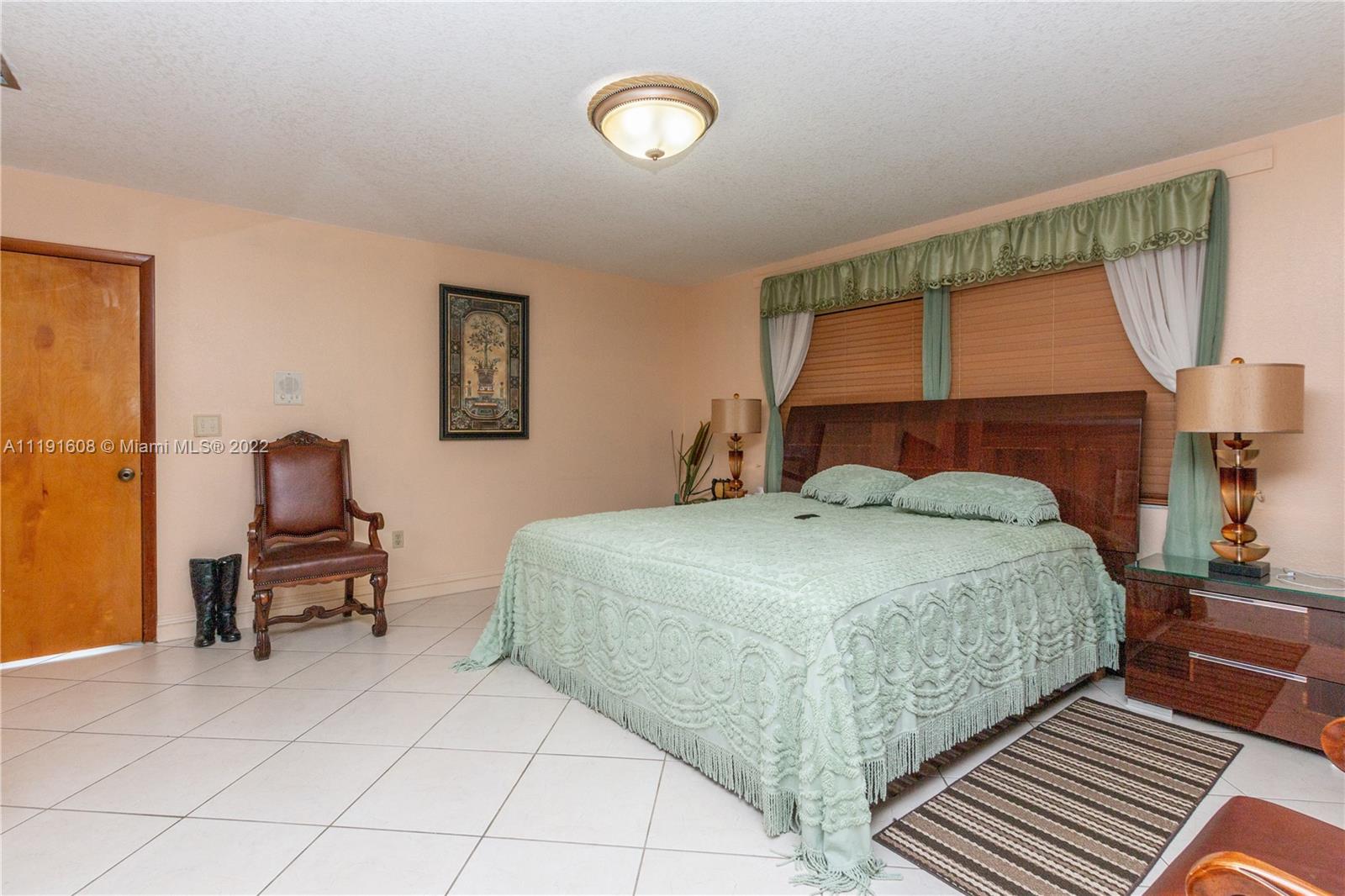 13560 Southwest 2nd Street Miami, FL 33184 - Photo 25 of 50 a bedroom with a bed and a large window