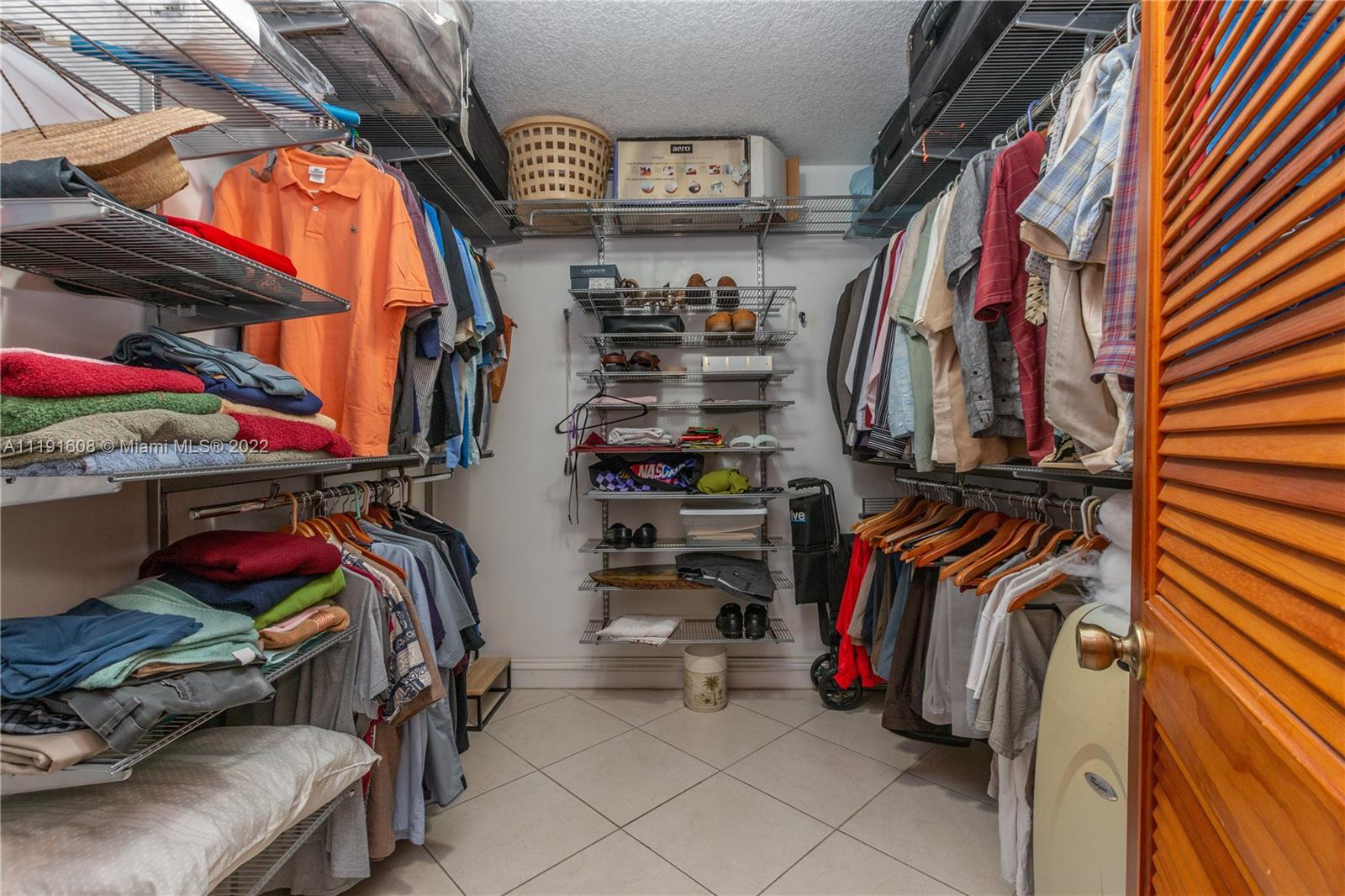 13560 Southwest 2nd Street Miami, FL 33184 - Photo 26 of 50 a view of walk in closet with clothes and shoes