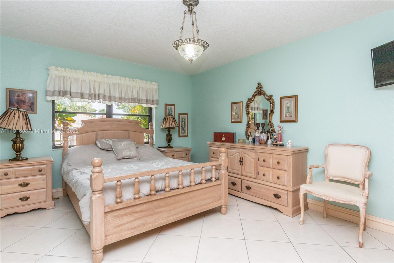 13560 Southwest 2nd Street Miami, FL 33184 - Photo 27 of 50 a bedroom with a bed and a window