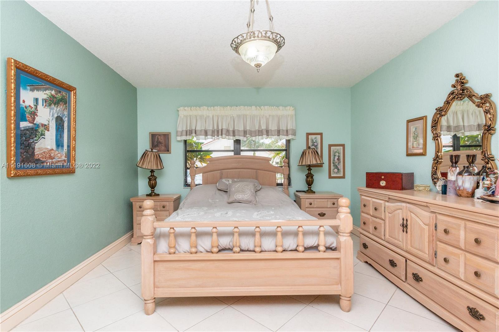 13560 Southwest 2nd Street Miami, FL 33184 - Photo 28 of 50 a bedroom with a bed and window