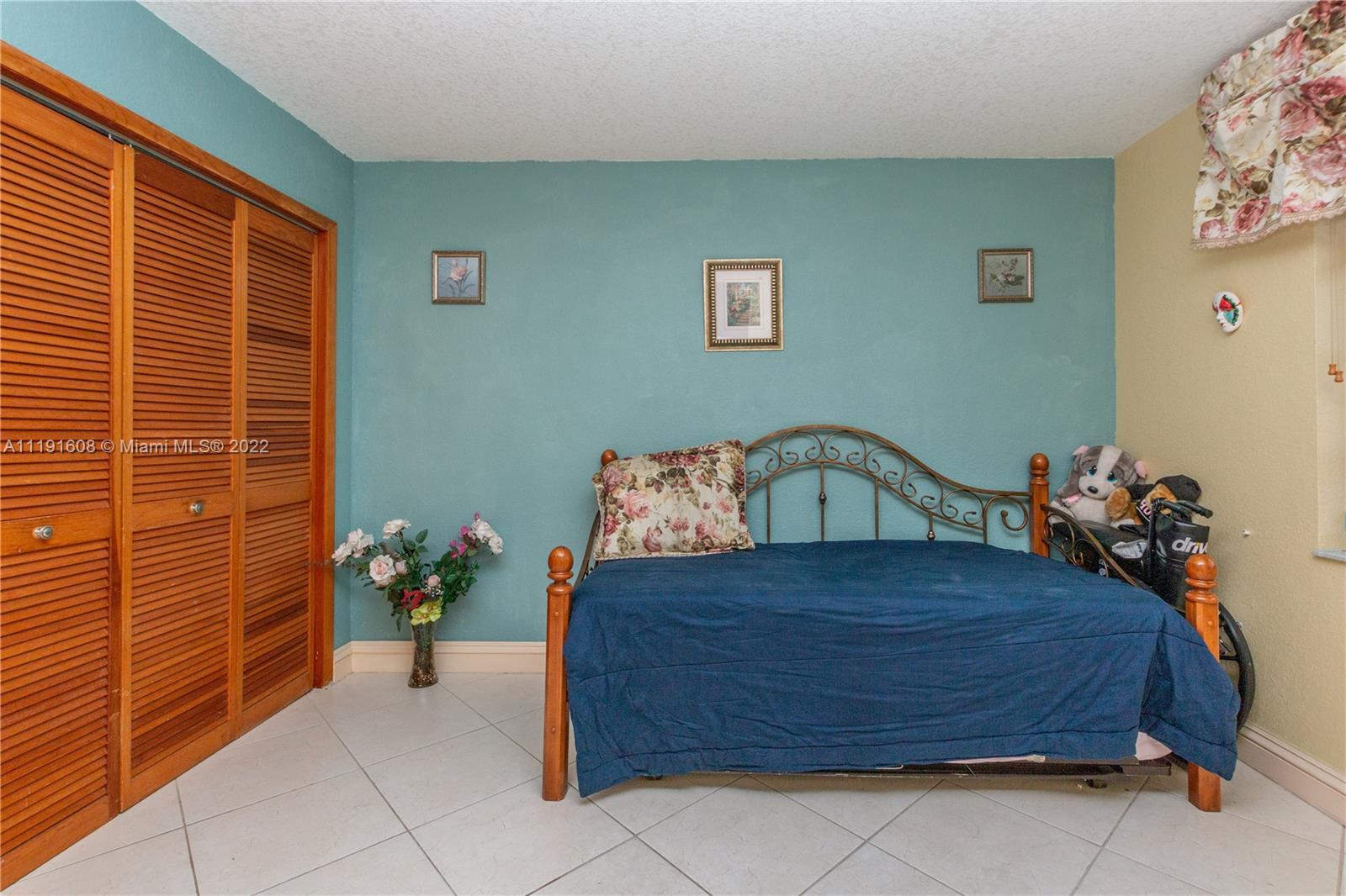 13560 Southwest 2nd Street Miami, FL 33184 - Photo 31 of 50 a bedroom with a bed and a potted plant