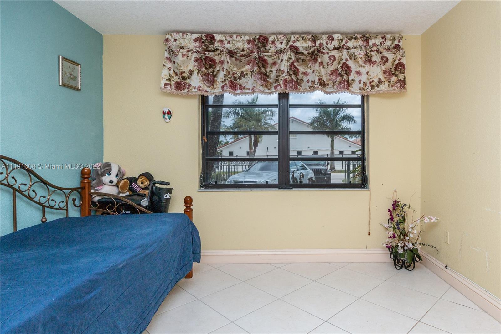 13560 Southwest 2nd Street Miami, FL 33184 - Photo 32 of 50 a bed room with a bed and a painting on the wall