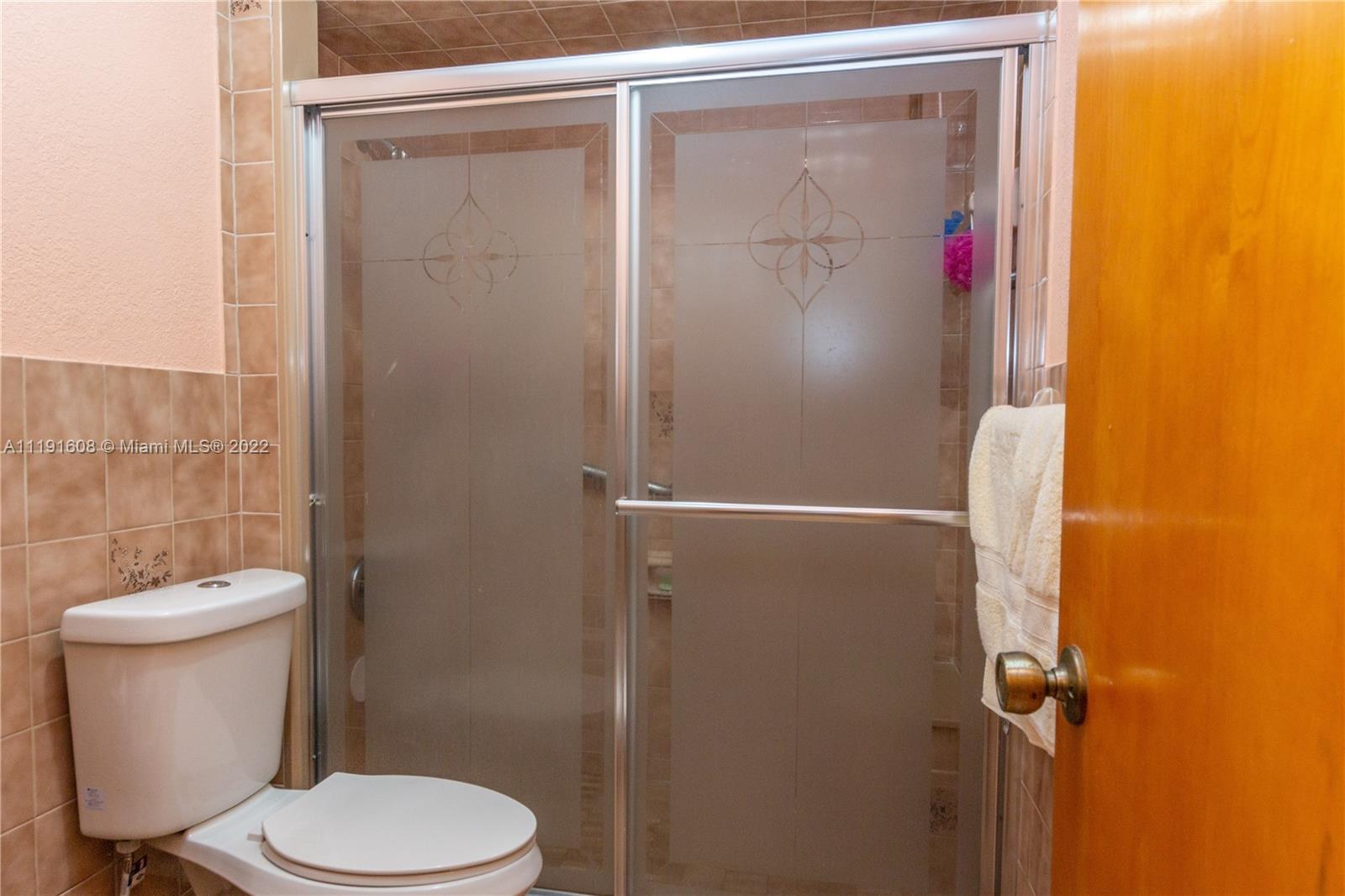 13560 Southwest 2nd Street Miami, FL 33184 - Photo 35 of 50 a white toilet sitting next to a shower