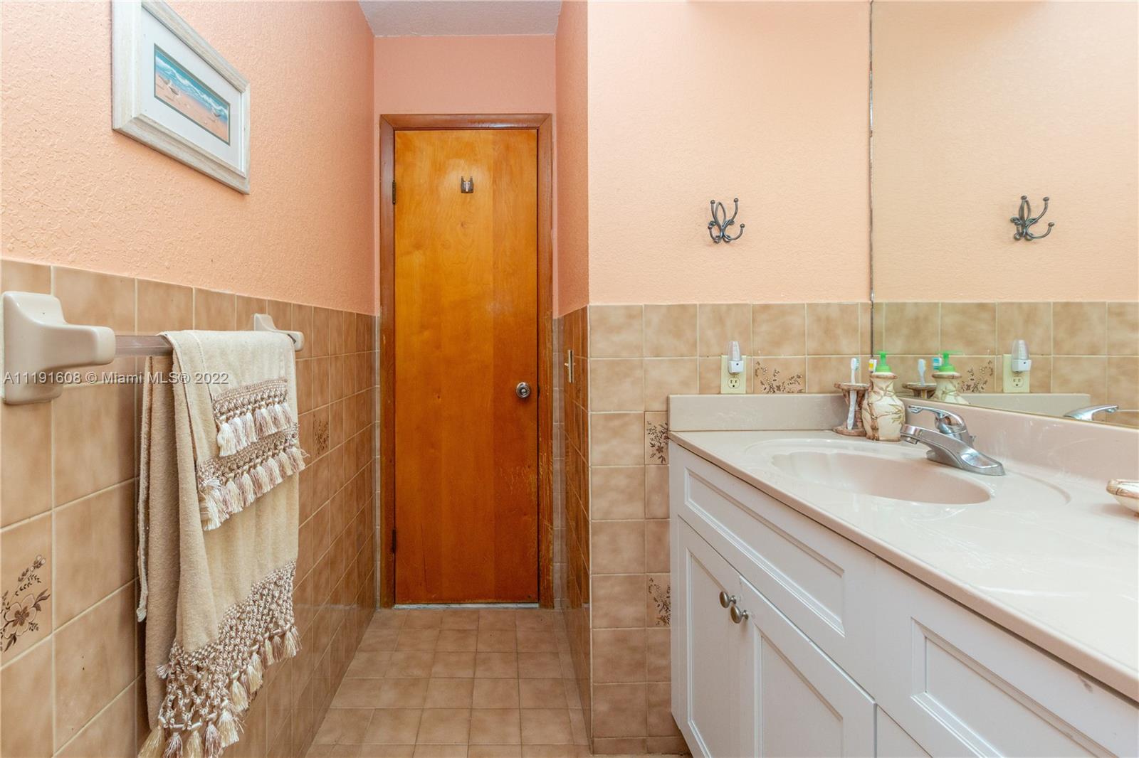 13560 Southwest 2nd Street Miami, FL 33184 - Photo 36 of 50 a bathroom with a sink and a mirror