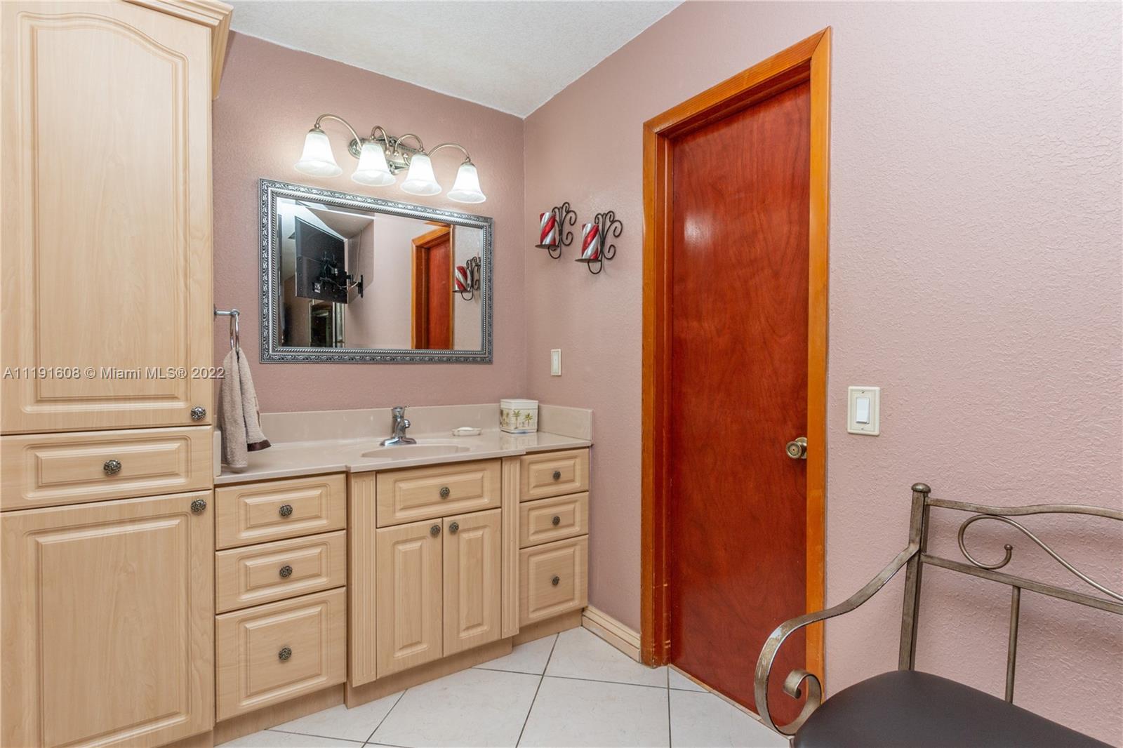 13560 Southwest 2nd Street Miami, FL 33184 - Photo 37 of 50 a bathroom with a double vanity sink and a mirror