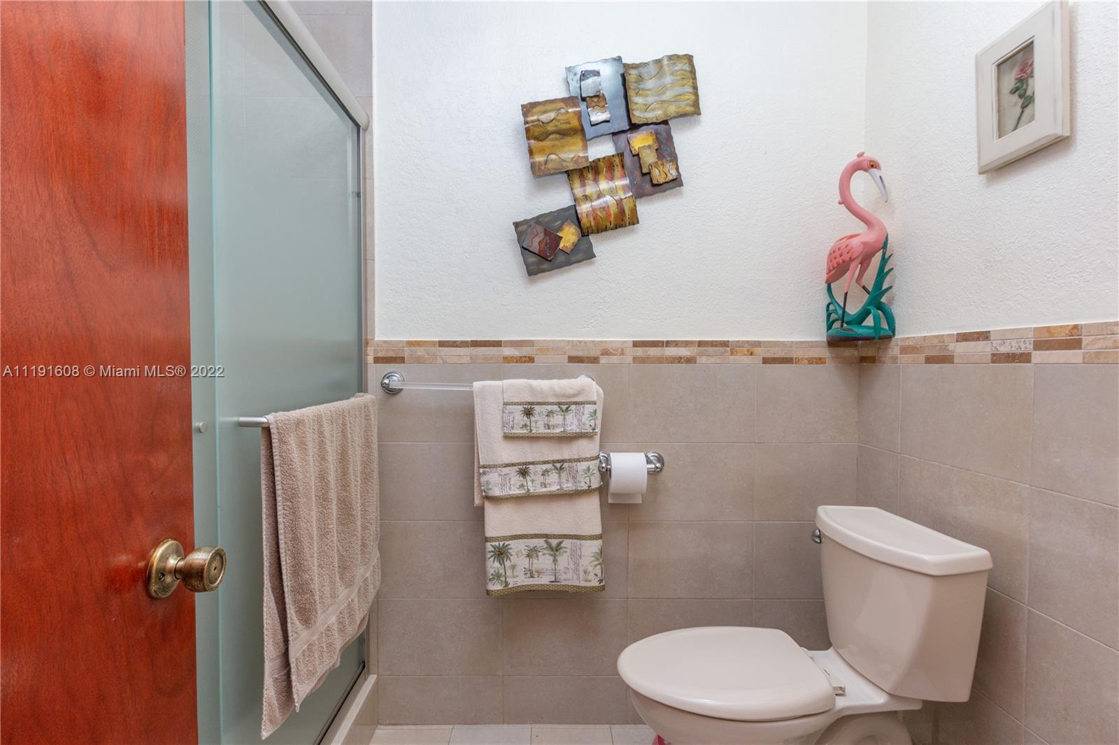 13560 Southwest 2nd Street Miami, FL 33184 - Photo 38 of 50 a bathroom with a toilet and a shower curtain