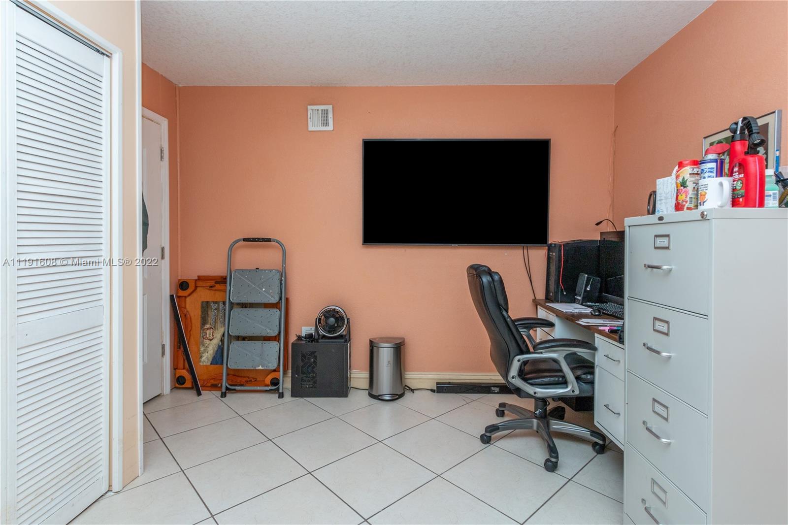 13560 Southwest 2nd Street Miami, FL 33184 - Photo 40 of 50 a view of a workspace with furniture and a window