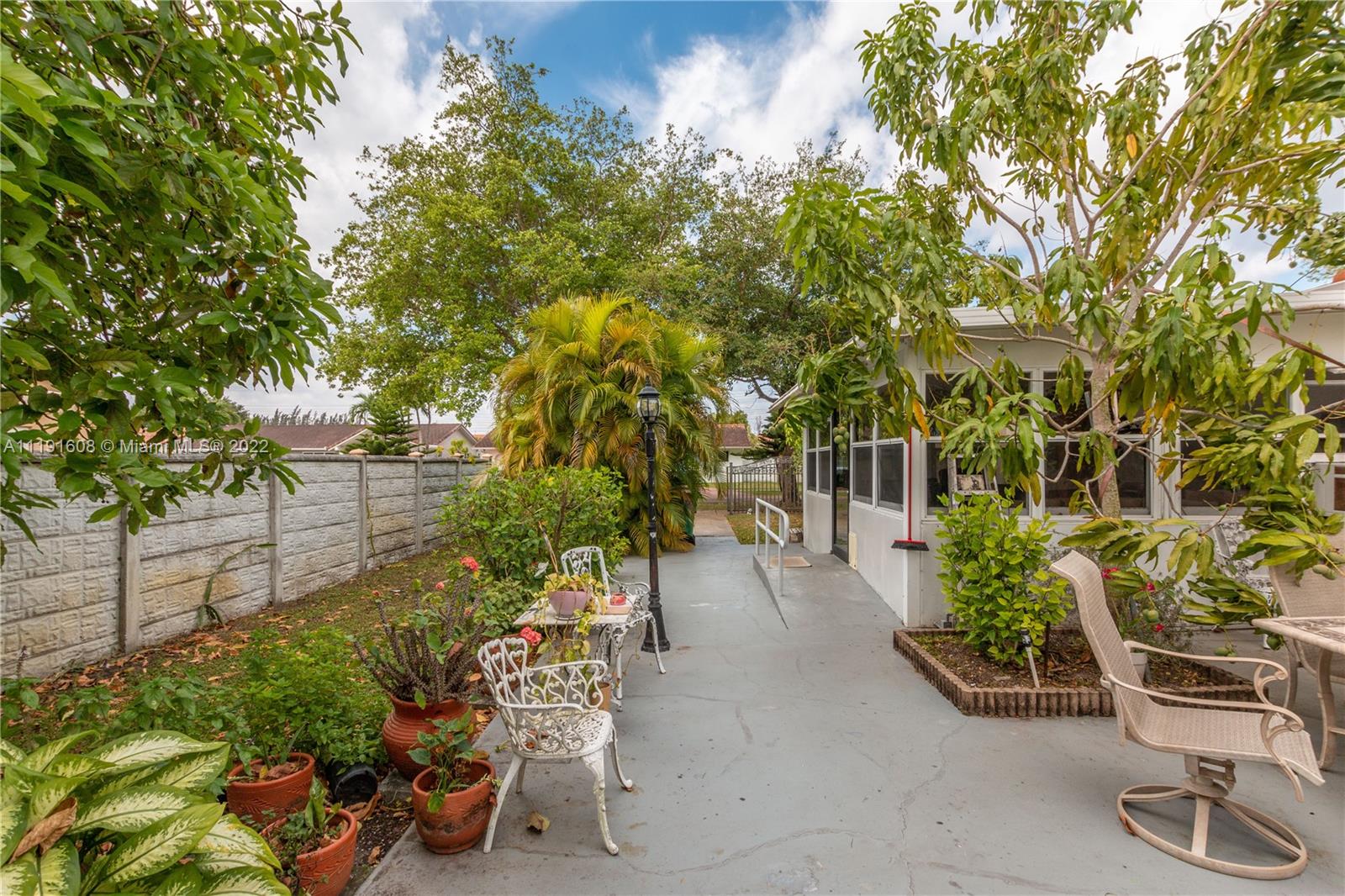 13560 Southwest 2nd Street Miami, FL 33184 - Photo 42 of 50 a view of a chairs and table in the garden