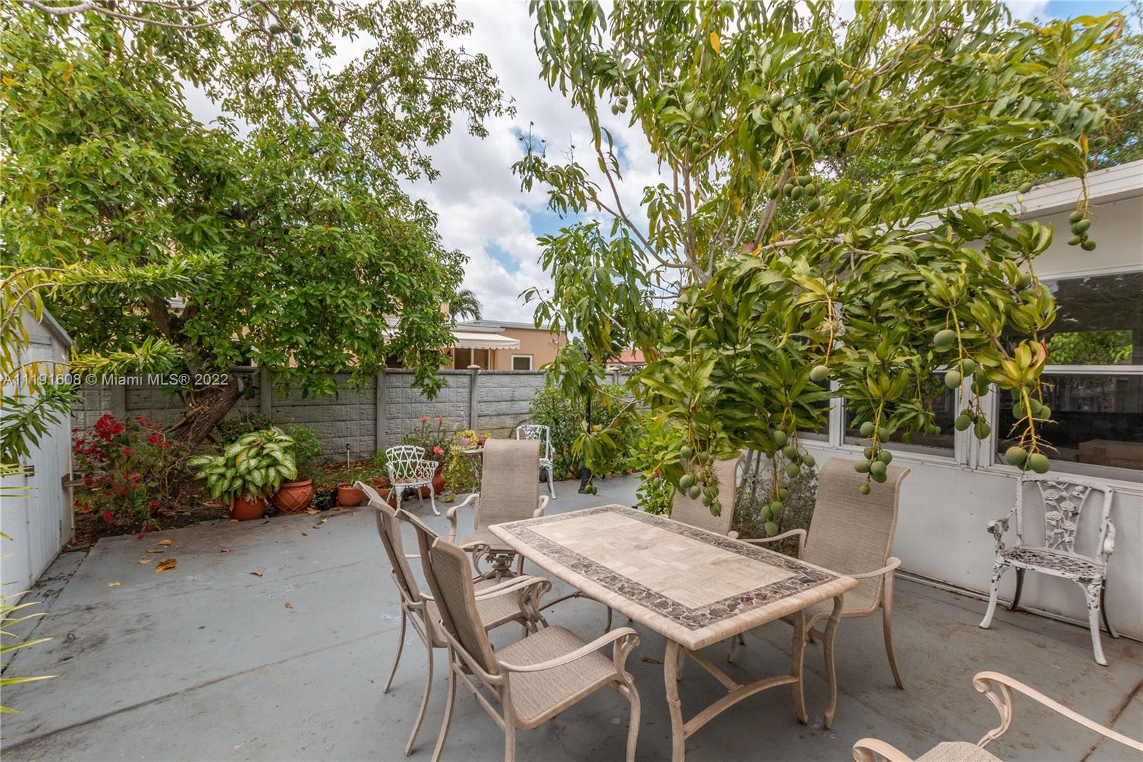 13560 Southwest 2nd Street Miami, FL 33184 - Photo 43 of 50 a view of a backyard with furniture and a garden