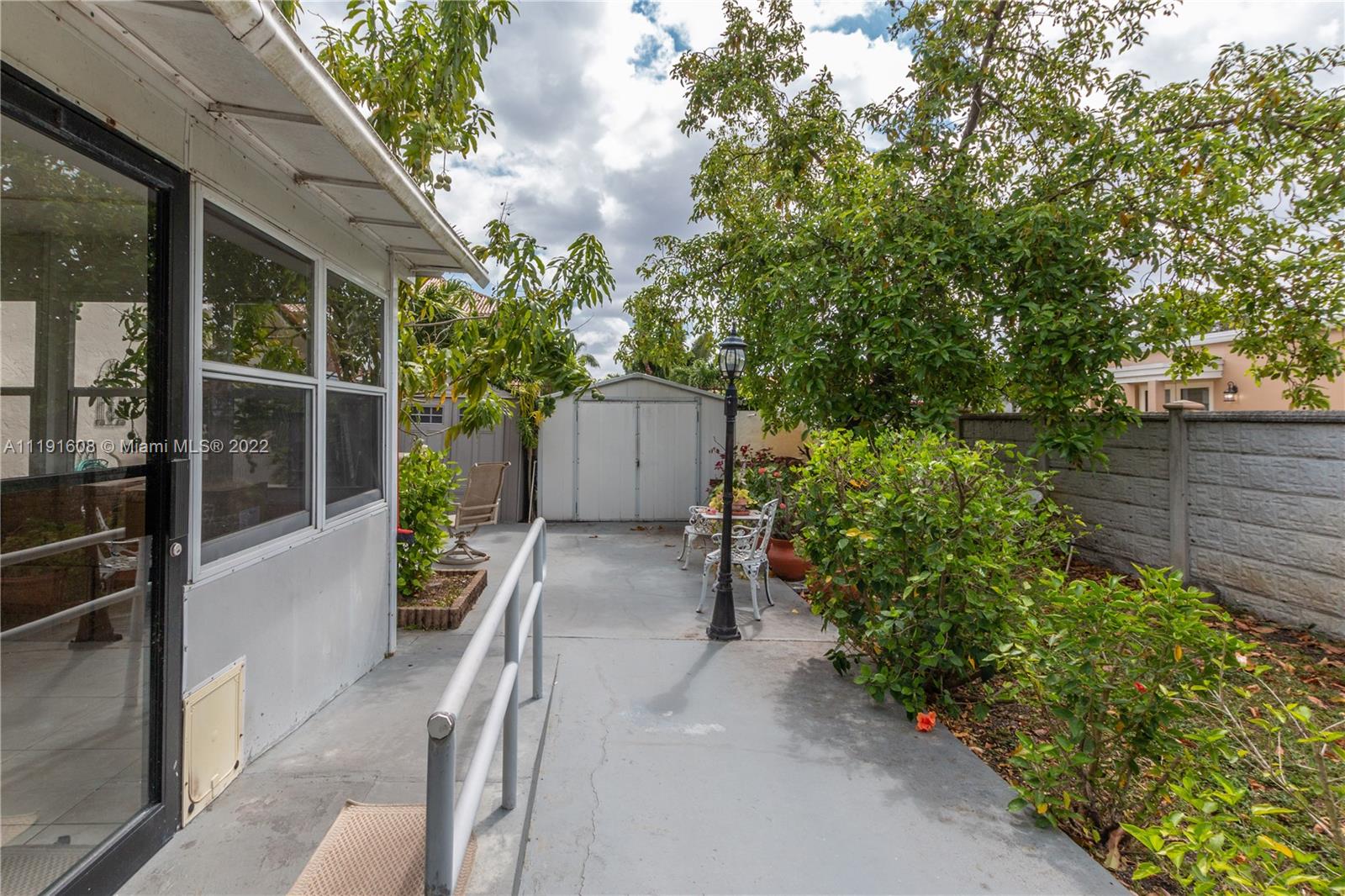 13560 Southwest 2nd Street Miami, FL 33184 - Photo 46 of 50 a view of a house with a yard and potted plants